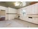 Spacious kitchen featuring wood cabinets, sink, natural lighting, and paneled ceiling at 310 Spring St, Durham, NC 27703