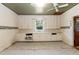 Kitchen featuring wood cabinets, sink, natural lighting, and paneled ceiling at 310 Spring St, Durham, NC 27703