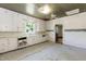 Spacious kitchen featuring wood cabinets, sink, natural lighting, and paneled ceiling at 310 Spring St, Durham, NC 27703