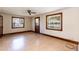 A bright living room featuring hardwood-style floors, white walls, and wood-trimmed windows at 310 Spring St, Durham, NC 27703