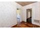 Room with textured wallpaper and access to adjacent rooms via white trim doorways at 310 Spring St, Durham, NC 27703