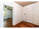Room with textured wallpaper, hardwood floors and trim, and access to adjacent rooms at 310 Spring St, Durham, NC 27703
