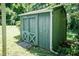 View of an exterior green storage shed, with double cross-buck doors at 310 Spring St, Durham, NC 27703