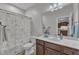 A full bathroom with a flower-patterned shower curtain and a vanity sink at 3106 Royal Deeside Ct, Zebulon, NC 27597