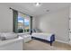 A bedroom with a blue bed frame and a window that provides natural light to the room at 3106 Royal Deeside Ct, Zebulon, NC 27597