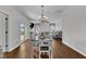 Open dining area with hardwood floors and natural light that opens to the living room and sliding door to the backyard at 3106 Royal Deeside Ct, Zebulon, NC 27597