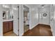Entryway with hardwood floors, a view of the bathroom and another bedroom, and a white front door at 3106 Royal Deeside Ct, Zebulon, NC 27597