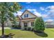 Charming home with stone accents, a covered porch, and lush landscaping, creating curb appeal at 3106 Royal Deeside Ct, Zebulon, NC 27597