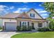 Charming two-story home boasts stone accents, a covered porch, an attached garage, and manicured landscaping at 3106 Royal Deeside Ct, Zebulon, NC 27597