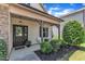 Inviting front porch featuring decorative wreath, seating area, and well-maintained landscaping for a welcoming entrance at 3106 Royal Deeside Ct, Zebulon, NC 27597