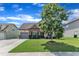 Attractive single-Gathering home with a manicured lawn, stone details, and a paved driveway at 3106 Royal Deeside Ct, Zebulon, NC 27597