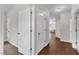 Hallway featuring wood floors and views of the living room and bedrooms at 3106 Royal Deeside Ct, Zebulon, NC 27597