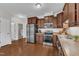 Well-lit kitchen featuring stainless steel appliances, wood cabinets, and wood-style flooring at 3106 Royal Deeside Ct, Zebulon, NC 27597