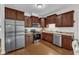 Spacious kitchen featuring stainless steel appliances, hardwood floors, and ample dark wood cabinetry at 3106 Royal Deeside Ct, Zebulon, NC 27597