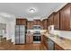 Well-lit kitchen featuring stainless steel appliances, beautiful wood cabinets, and stylish countertops at 3106 Royal Deeside Ct, Zebulon, NC 27597