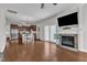 An open-concept living room with hardwood floors and fireplace that flows into the dining area and kitchen at 3106 Royal Deeside Ct, Zebulon, NC 27597