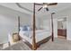 Comfortable main bedroom suite featuring a tray ceiling, four poster bed and en-suite bath at 3106 Royal Deeside Ct, Zebulon, NC 27597
