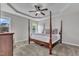 Spacious main bedroom featuring a tray ceiling, four-poster bed, and large windows at 3106 Royal Deeside Ct, Zebulon, NC 27597
