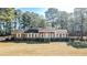 Charming brick home with a well-manicured lawn and mature trees at 3129 Barwell Rd, Raleigh, NC 27610