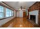 Cozy living room features a brick fireplace and hardwood floors at 3129 Barwell Rd, Raleigh, NC 27610