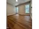 Spacious bedroom featuring wood flooring and a large window with natural light at 3212 Potthast Ct, Raleigh, NC 27529