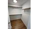 Walk-in closet with custom shelving and wood flooring at 3212 Potthast Ct, Raleigh, NC 27529