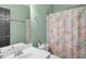 Bathroom with neutral tile, single sink, and floral shower curtain at 322 Tobacco Farm Way, Chapel Hill, NC 27516