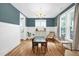 A dining room features hardwood floors, natural light, and wainscotting details at 322 Tobacco Farm Way, Chapel Hill, NC 27516