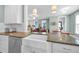 Modern kitchen featuring granite countertops and a large farmhouse sink with stainless steel appliances at 322 Tobacco Farm Way, Chapel Hill, NC 27516