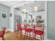 Eat-in kitchen featuring granite countertops, stainless appliances, hardwood floors and seating at the counter at 322 Tobacco Farm Way, Chapel Hill, NC 27516