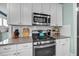 Kitchen featuring a stainless steel oven, granite counters, and white cabinets at 322 Tobacco Farm Way, Chapel Hill, NC 27516