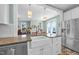 Bright kitchen features granite countertops, stainless steel appliances, and a farmhouse sink at 322 Tobacco Farm Way, Chapel Hill, NC 27516