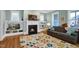 Inviting living room with a fireplace, built-in shelving, and a comfortable sofa in a well-lit space at 322 Tobacco Farm Way, Chapel Hill, NC 27516