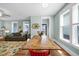 Open floor plan features hardwood floors, lots of light, a dining room, and a living room with a comfortable sofa at 322 Tobacco Farm Way, Chapel Hill, NC 27516
