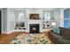 Bright living room featuring a fireplace, built-in shelving, and a comfortable sofa with views from windows at 322 Tobacco Farm Way, Chapel Hill, NC 27516