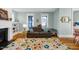 Cozy living room featuring hardwood floors, a fireplace, and a comfortable sofa with bright pillows at 322 Tobacco Farm Way, Chapel Hill, NC 27516