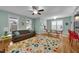 Spacious living room featuring hardwood floors, large windows, and access to the dining area at 322 Tobacco Farm Way, Chapel Hill, NC 27516