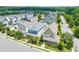 An aerial view shows a vibrant neighborhood with colorful homes, manicured lawns, and lush green trees at 322 Tobacco Farm Way, Chapel Hill, NC 27516