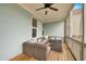 Relaxing screened patio with comfortable seating and ceiling fan at 322 Tobacco Farm Way, Chapel Hill, NC 27516