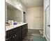 Bathroom featuring double sinks, dark cabinets, and a tiled walk-in shower at 3428 Pinnacle Peak Dr, Raleigh, NC 27604