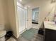 Bathroom featuring tiled walk-in shower with a door leading to a bedroom at 3428 Pinnacle Peak Dr, Raleigh, NC 27604