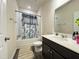 Bathroom featuring dark vanity and a shower-tub combo at 3428 Pinnacle Peak Dr, Raleigh, NC 27604