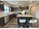 Modern kitchen with stainless steel appliances, dark cabinets, granite counters, and a breakfast bar at 3428 Pinnacle Peak Dr, Raleigh, NC 27604