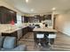 Modern kitchen with stainless steel appliances, dark cabinets, granite counters, and a breakfast bar at 3428 Pinnacle Peak Dr, Raleigh, NC 27604