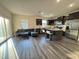 Open concept kitchen and living area with dark cabinetry, stainless appliances, and hardwood flooring at 3428 Pinnacle Peak Dr, Raleigh, NC 27604