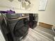 Laundry room featuring matching Samsung washer and dryer on wood grain floors at 3428 Pinnacle Peak Dr, Raleigh, NC 27604
