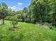 Lush backyard features a garden and wooded backdrop, perfect for outdoor enjoyment at 3581 Boulder Ct, Wake Forest, NC 27587