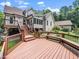 Spacious backyard featuring a house, garden, and large wooden deck at 3581 Boulder Ct, Wake Forest, NC 27587