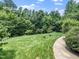 Expansive, lush backyard featuring a concrete walkway at 3581 Boulder Ct, Wake Forest, NC 27587