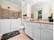 Bright bathroom featuring a walk-in tub, granite countertop, and white cabinetry at 3581 Boulder Ct, Wake Forest, NC 27587